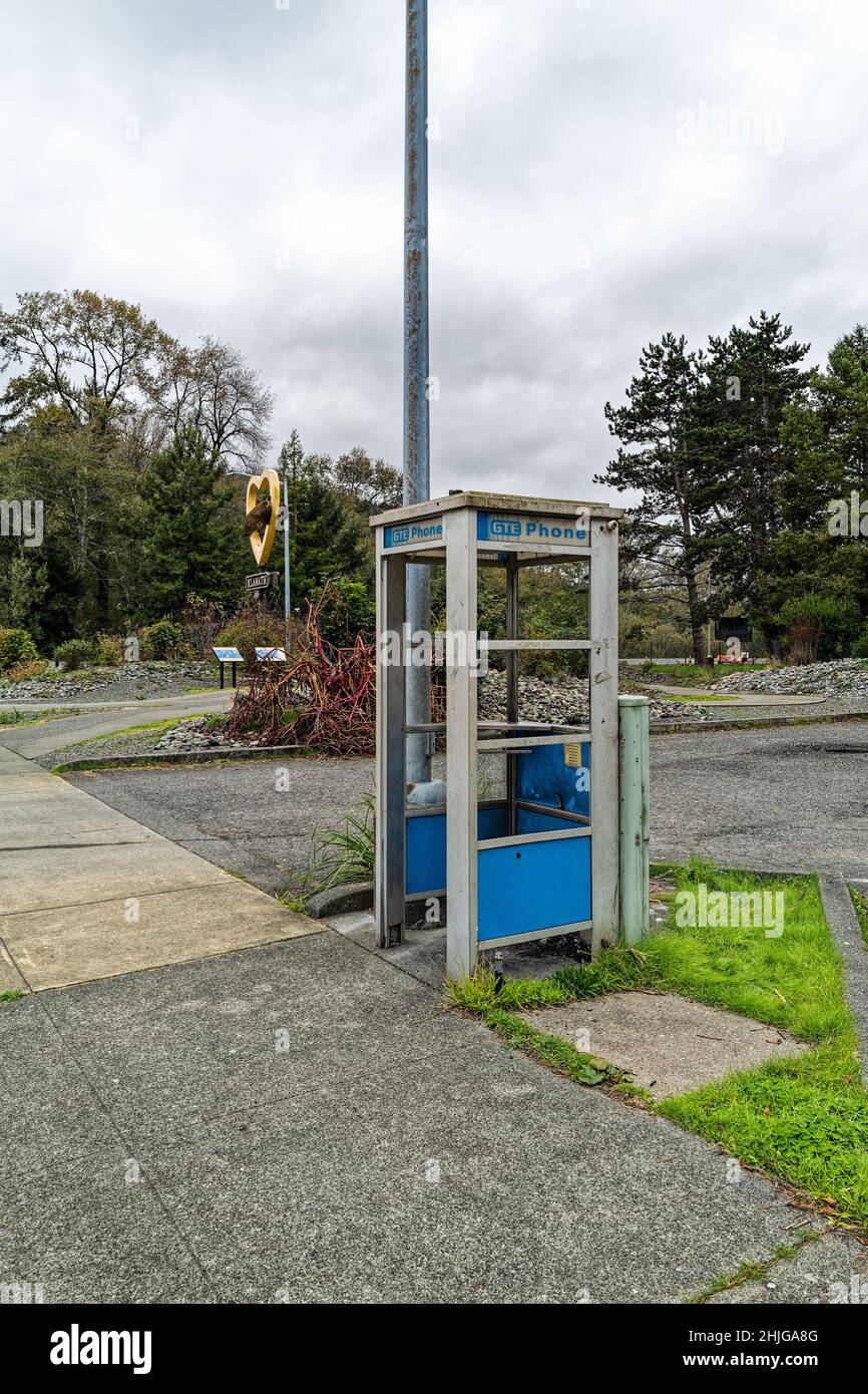 A blue phone booth on a sidewalk in Klamath, Oregon, USA Stock Photo