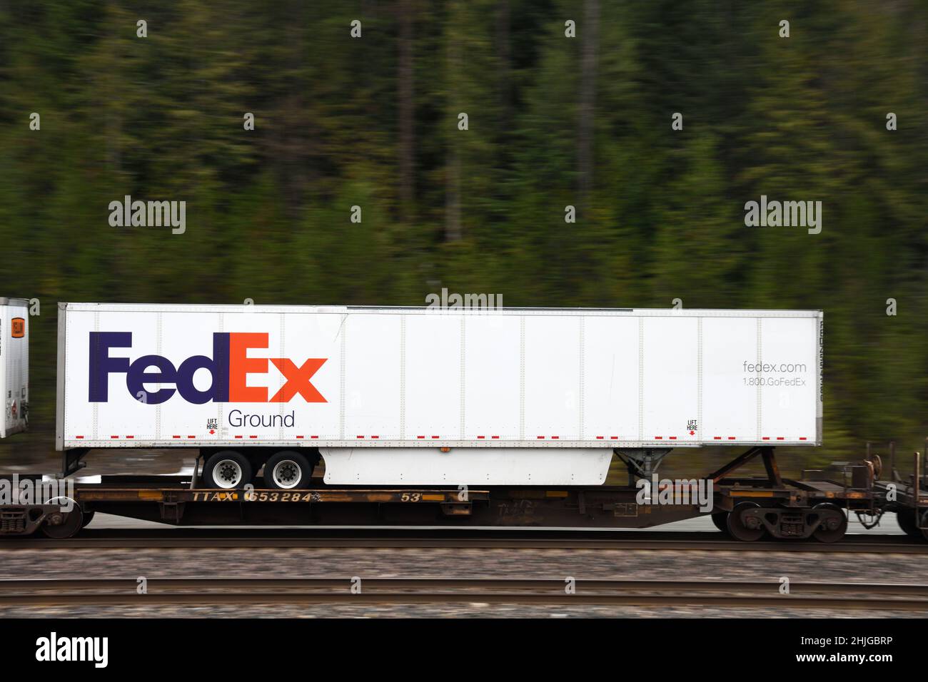 A Fedex intermodal shipping container on the BNSF railway along their Northern Transcon route running from Seattle to Chicago. Near Troy, Montana. Stock Photo