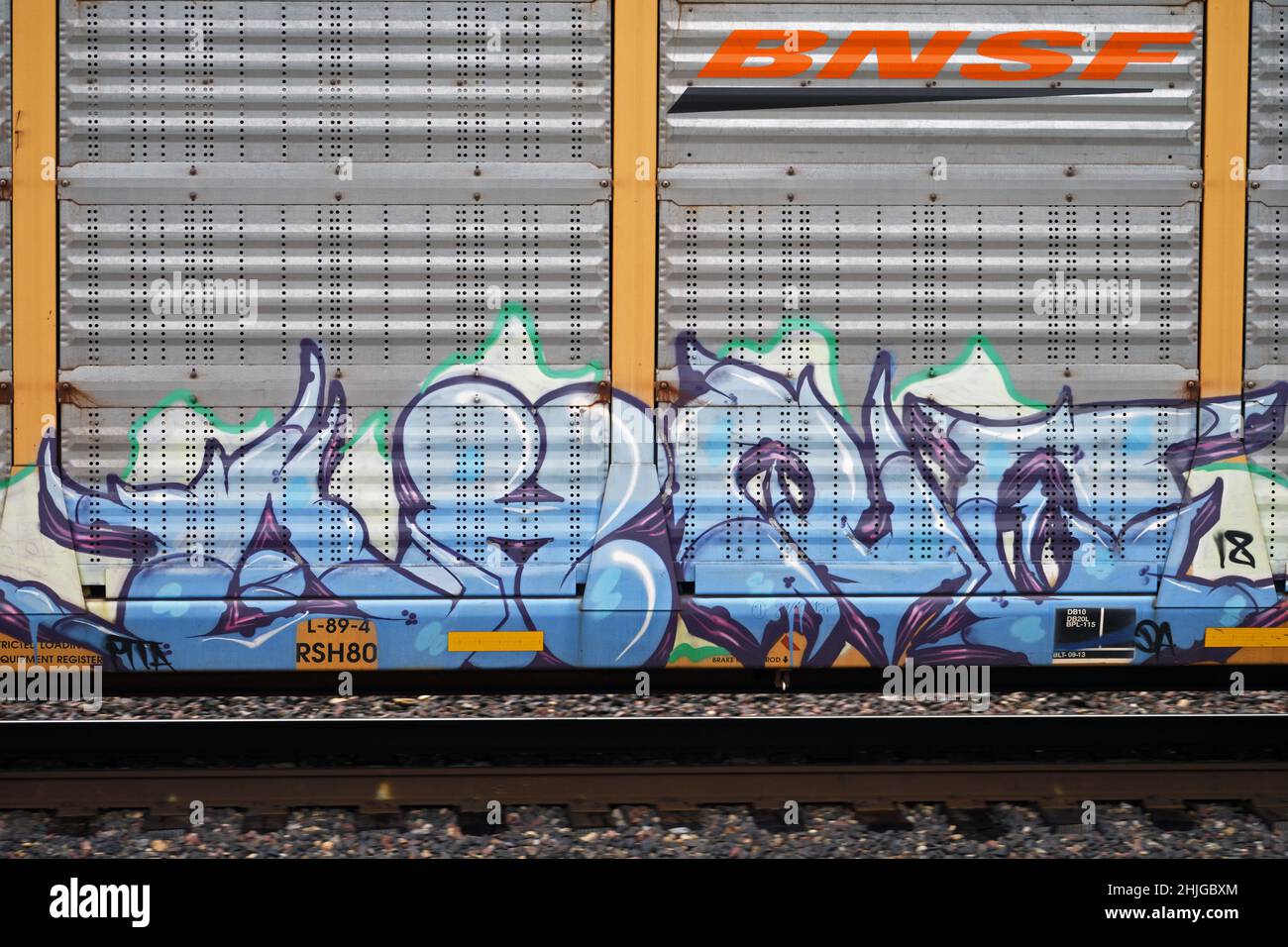Graffiti painted on BNSF shipping container traveling on the Northern Transcon route that runs from Chicago to Seattle. Near Troy, Montana. Stock Photo