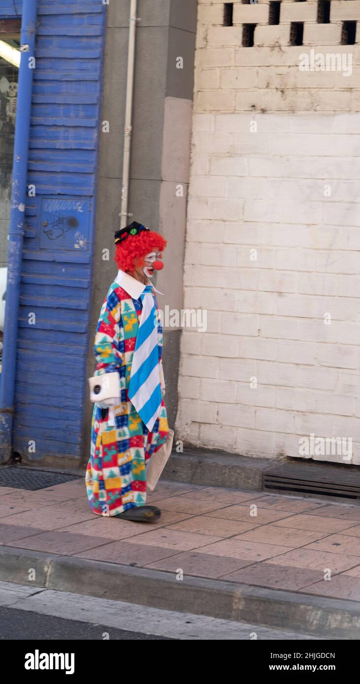 Man dressed as a clown walking on a street in Zaragoza,one of Europe’s