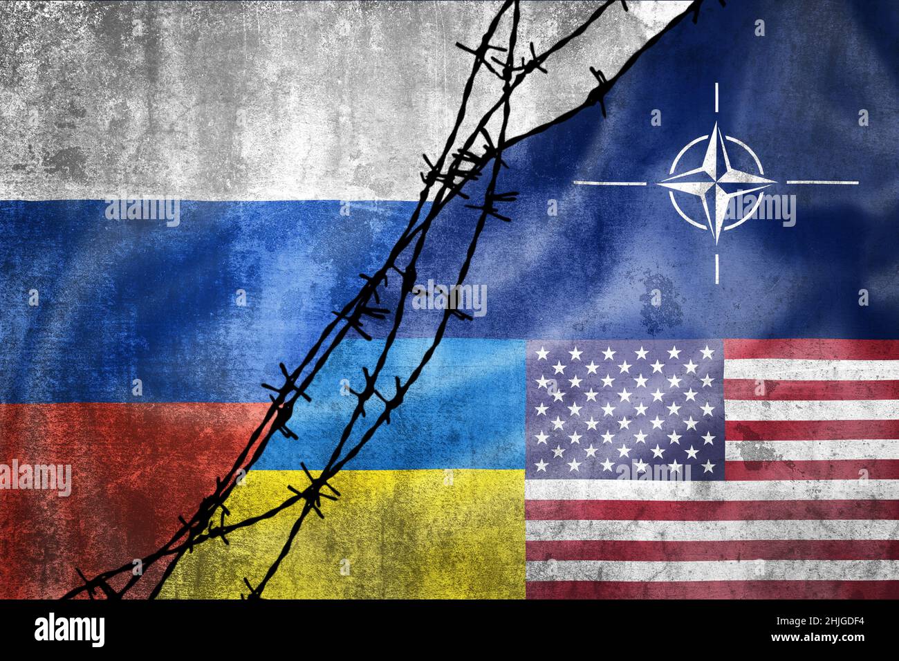 Grunge flags of Russian Federation, NATO, USA and Ukraine divided by barb wire illustration, concept of tense relations between west and Russia Stock Photo
