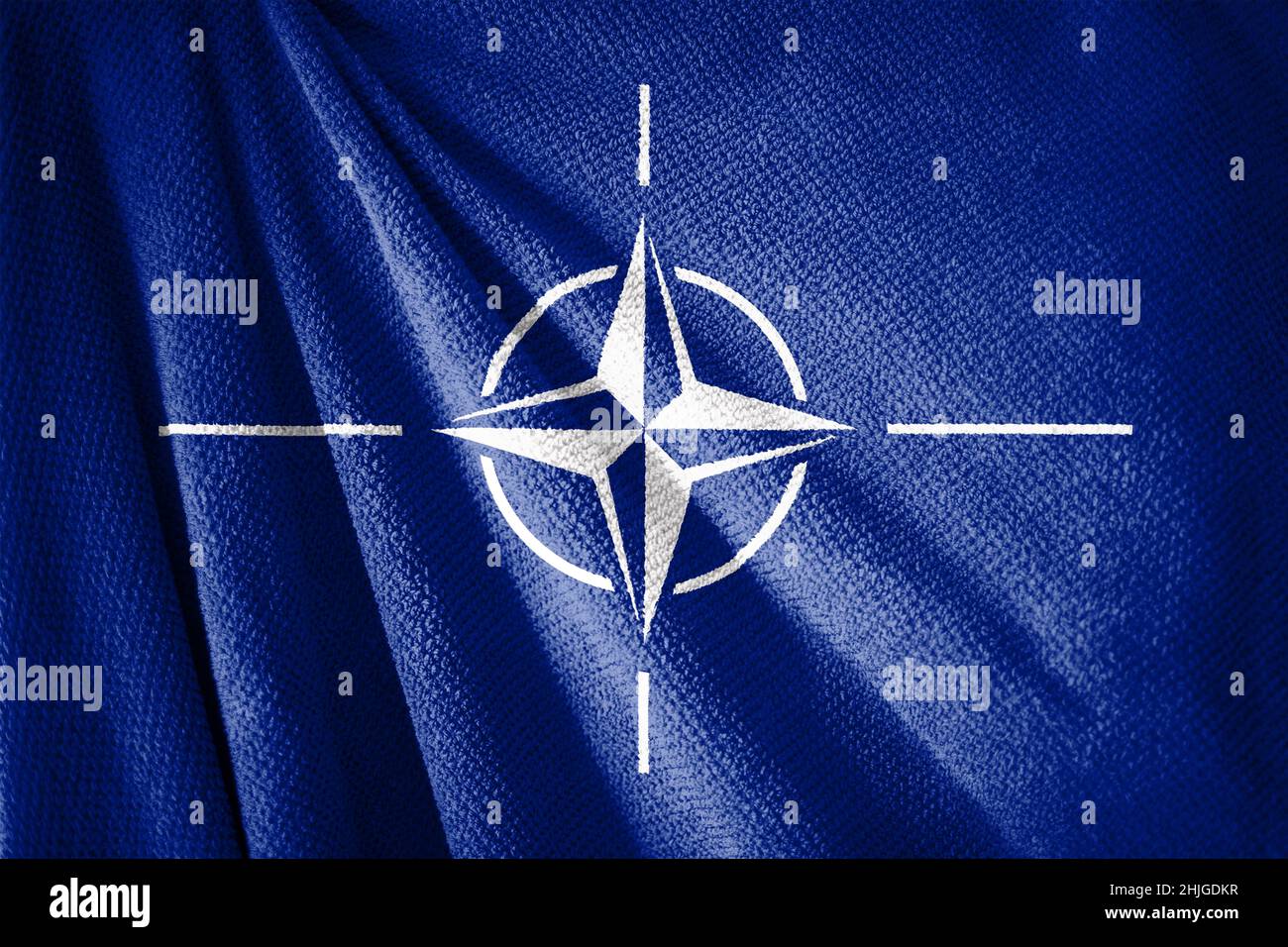 NATO flag on towel surface illustration with, symbol of military alliance Stock Photo