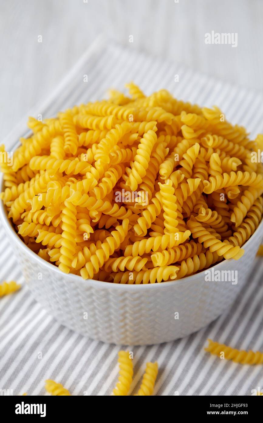 Raw Dry Organic Rotini Pasta Ready to Cook, side view. Closeup Stock