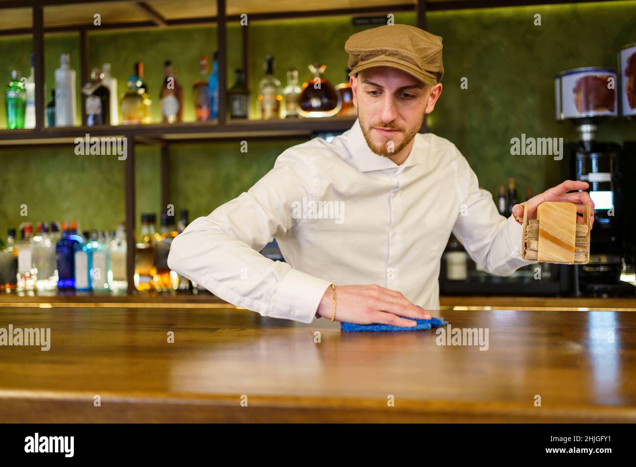 Bartender cleaning counter in a nice pub Stock Photo