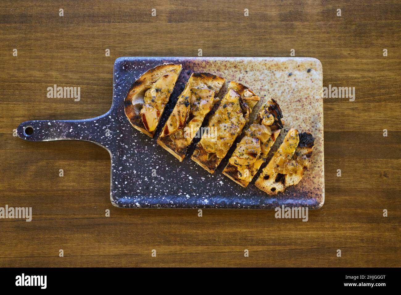 Cut toast of foie served on board Stock Photo