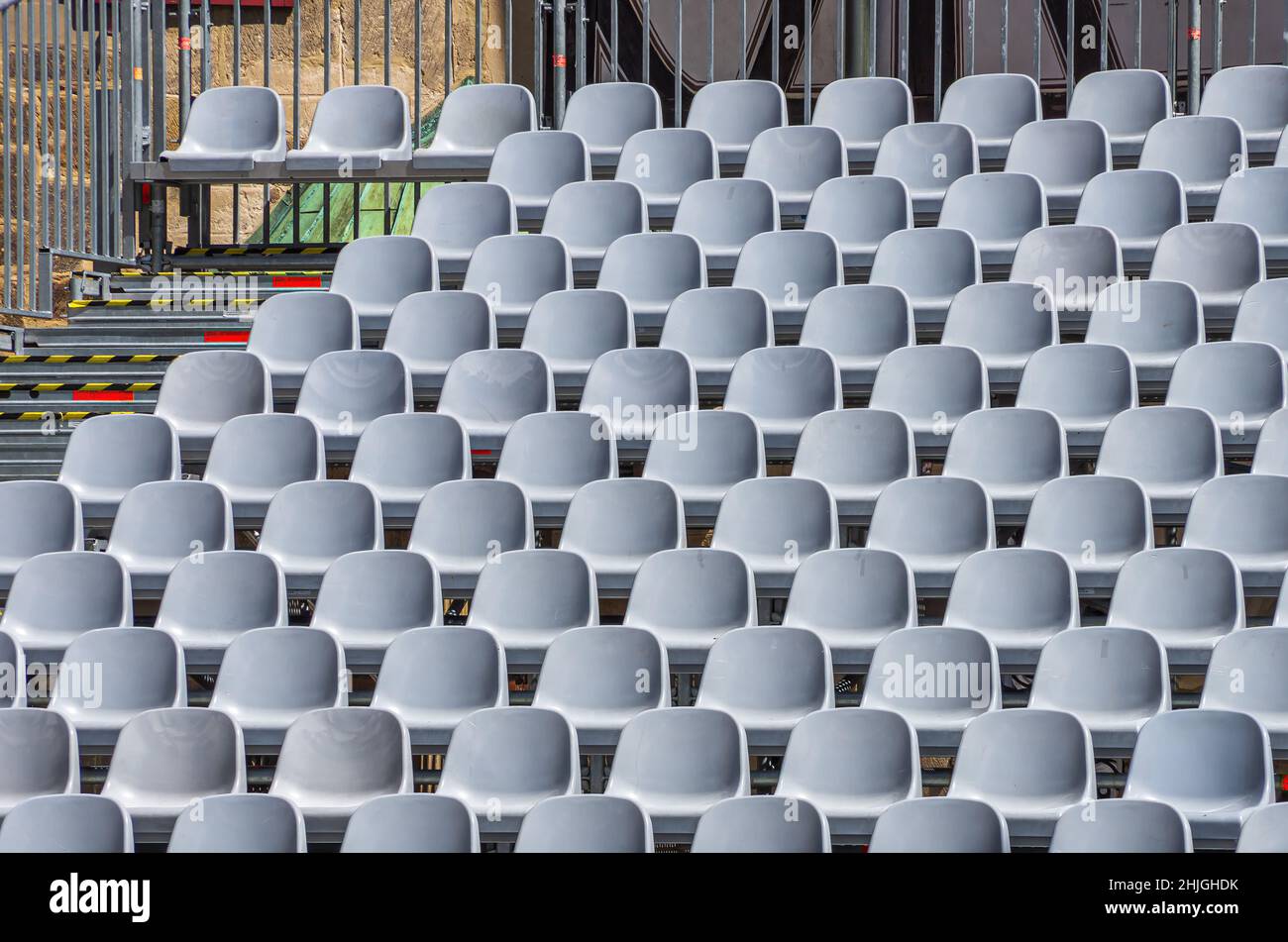 Empty rows of seats of a grandstand inside an open air venue. Stock Photo