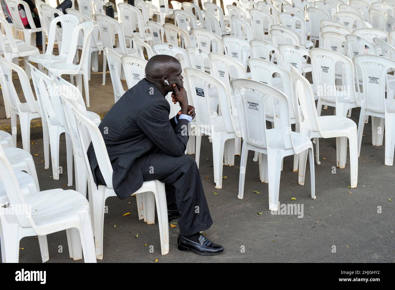 KENYA, Nairobi, man on plastic chair so called monobloc / KENIA