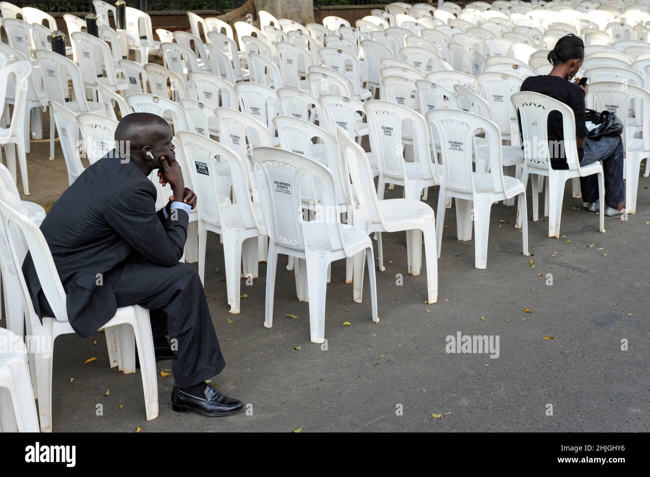 KENYA, Nairobi, man on plastic chair so called monobloc / KENIA, Nairobi, Mann auf Plastik Stuhl, monoblock aus Polypropylen Stock Photo