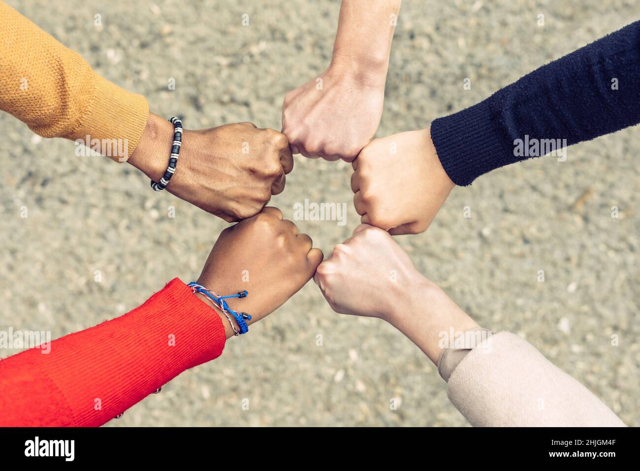 zenithal view of 5 clenched fists forming a pentagon Stock Photo