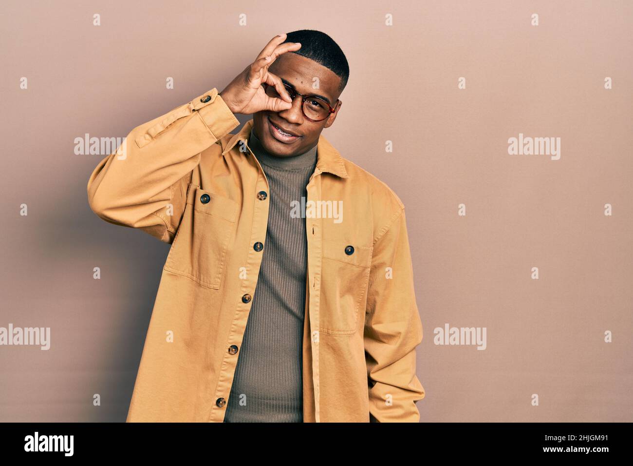 Young black man wearing casual clothes and glasses smiling happy doing ...