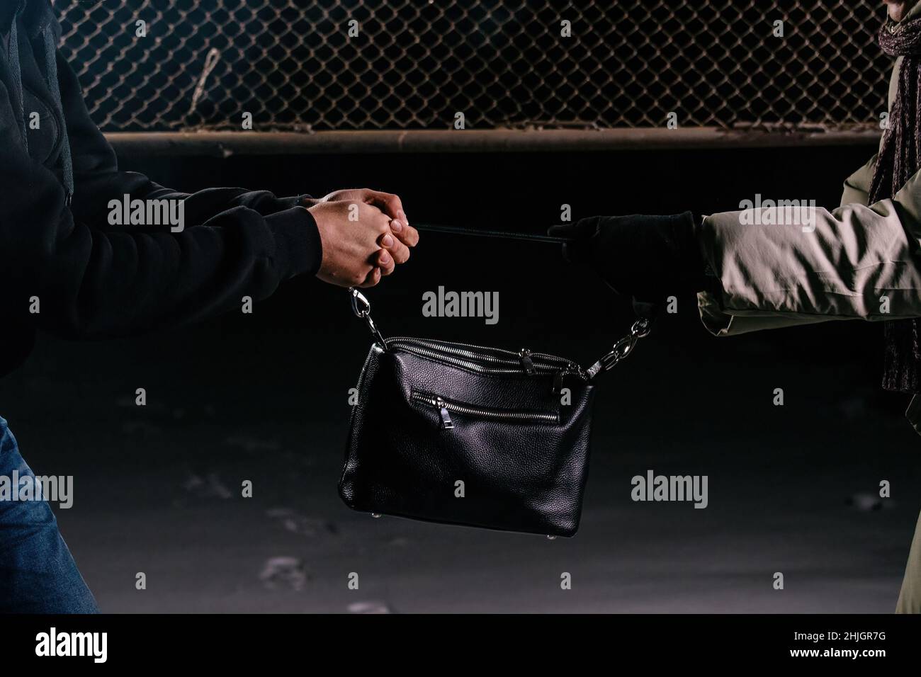 Crime scene. Robber trying to snatch bag, close up. Stock Photo