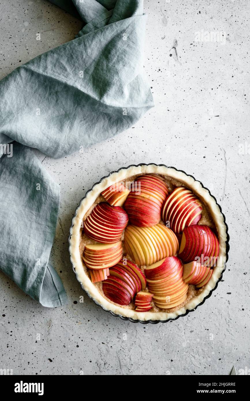 An apple tart pre-bake with a blue linen Stock Photo