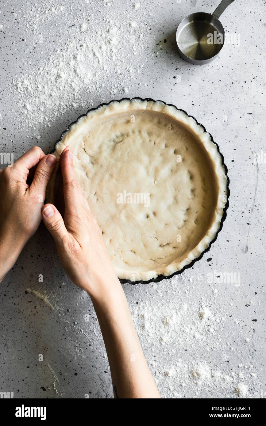 A baker making a tart shell Stock Photo