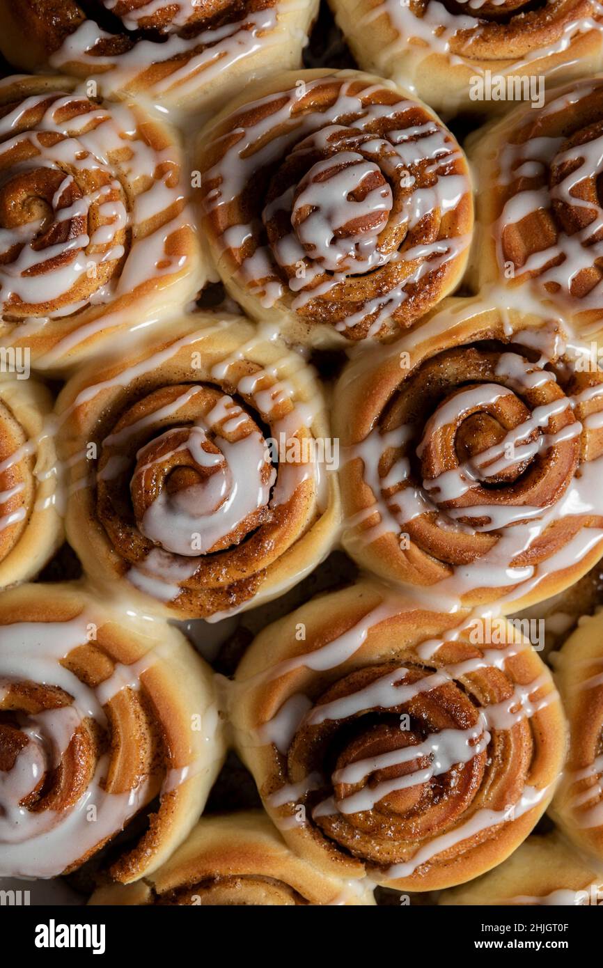 Cinnamon Roll pastries covered in drizzled icing Stock Photo - Alamy