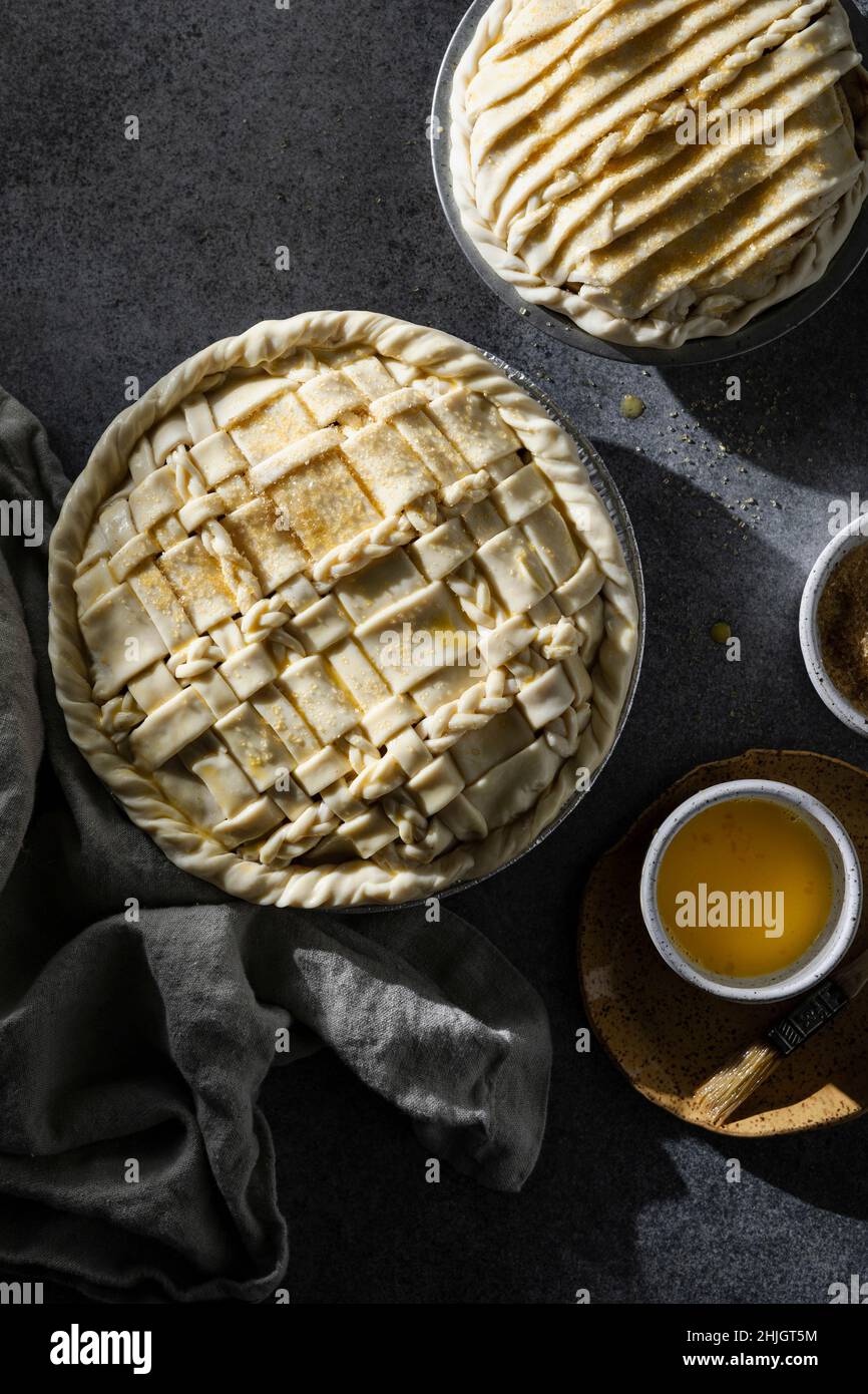 Two pies with lattice crust on dark neutral background Stock Photo