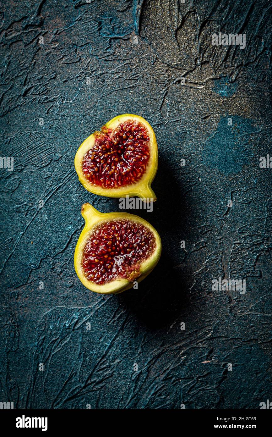 Figs Close Up, halved on a blue background Stock Photo