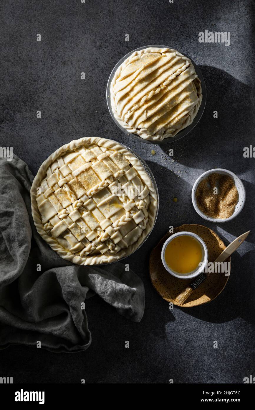 Two pies with lattice crust on dark neutral background Stock Photo