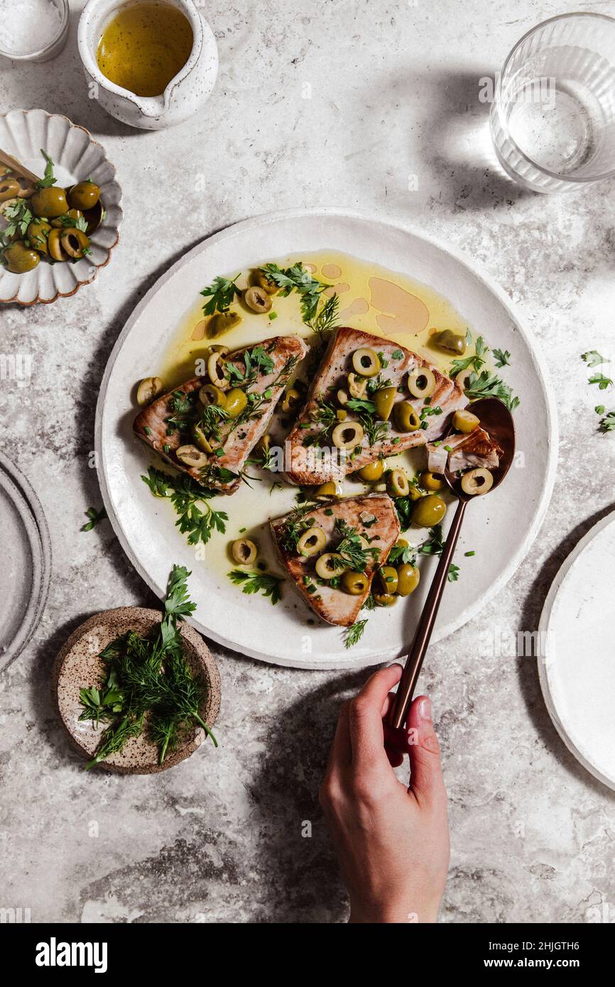 roasted tuna with olives and herbs Stock Photo