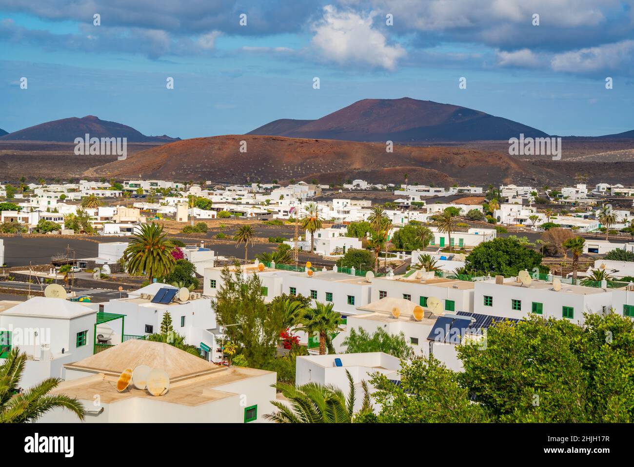 View of town from elevated position with mountainous backdrop, Yaisa, Lanzarote, Canary Islands, Spain, Europe Stock Photo