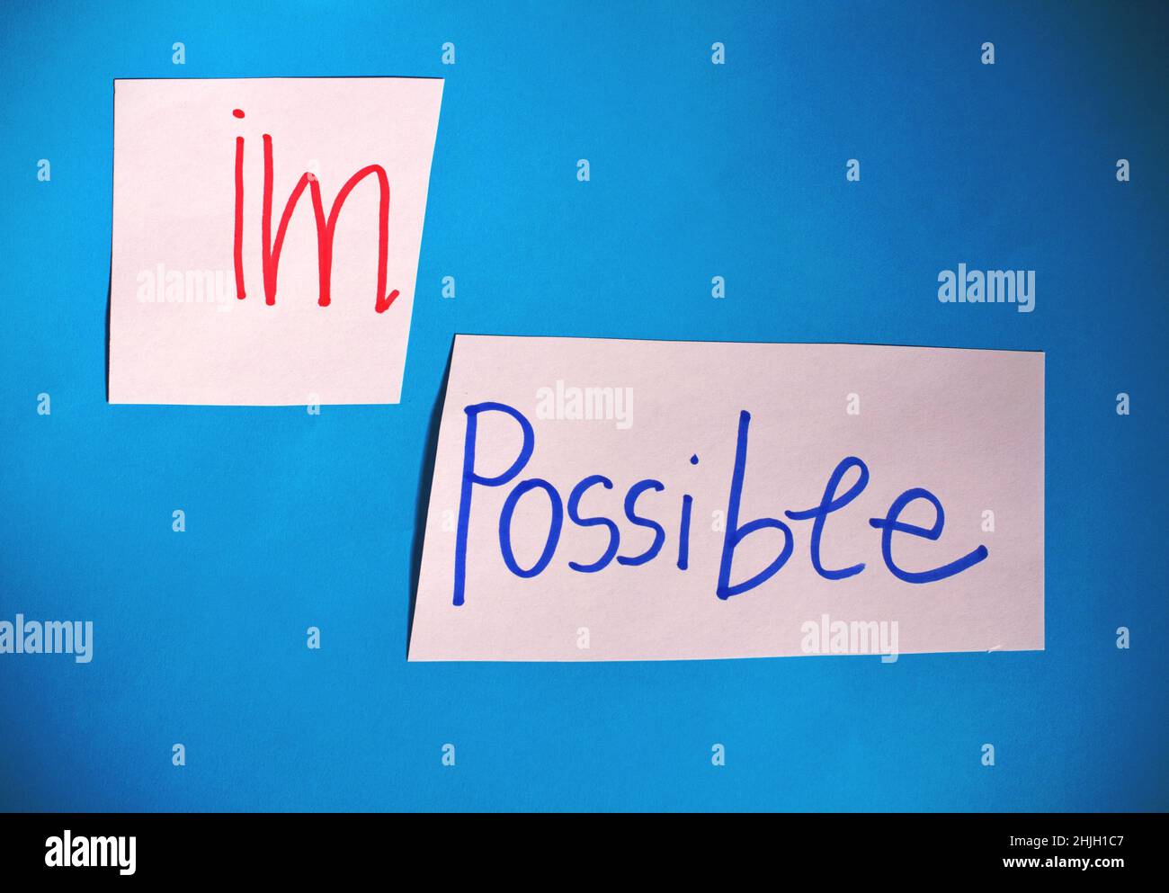 Card with the text impossible, cutting the word im so it written ...