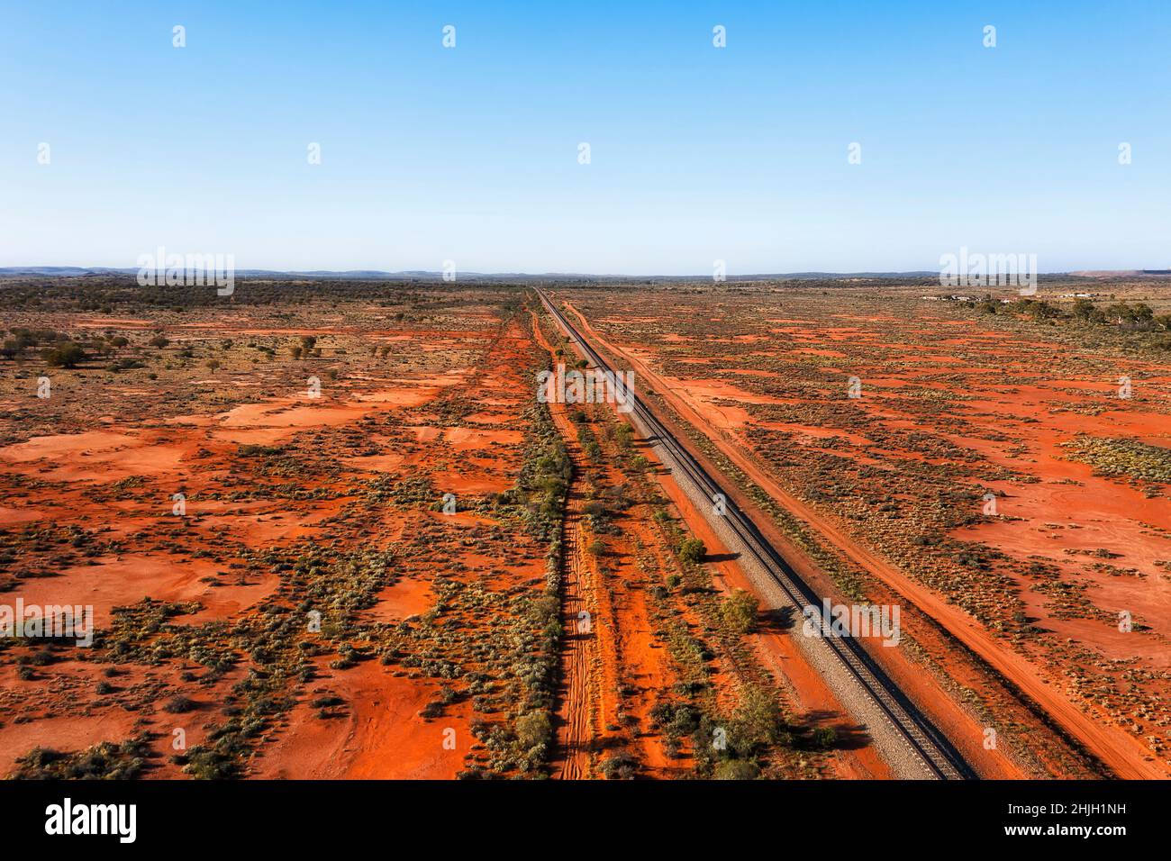 Extreme terrain of remote red soil outback in Australia around Broken hill and railway track - aerial landscape. Stock Photo