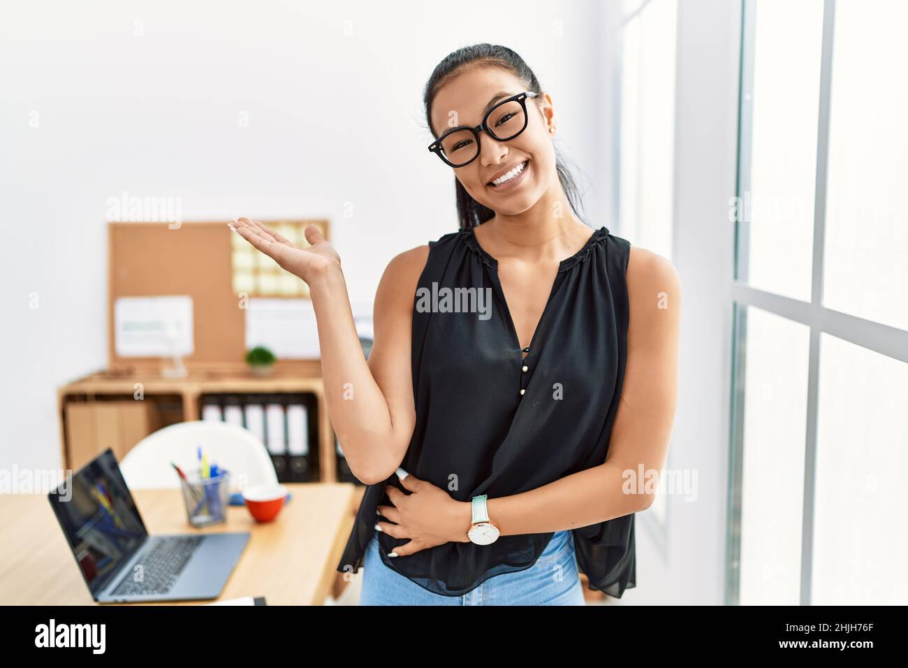 Young hispanic business woman working at the office smiling cheerful ...