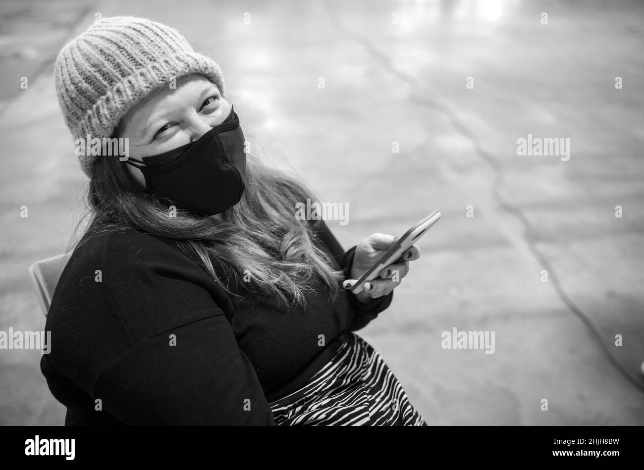 Female all covered up in compliance with New York City mandate in reducing the risk of COVID-19. Stock Photo