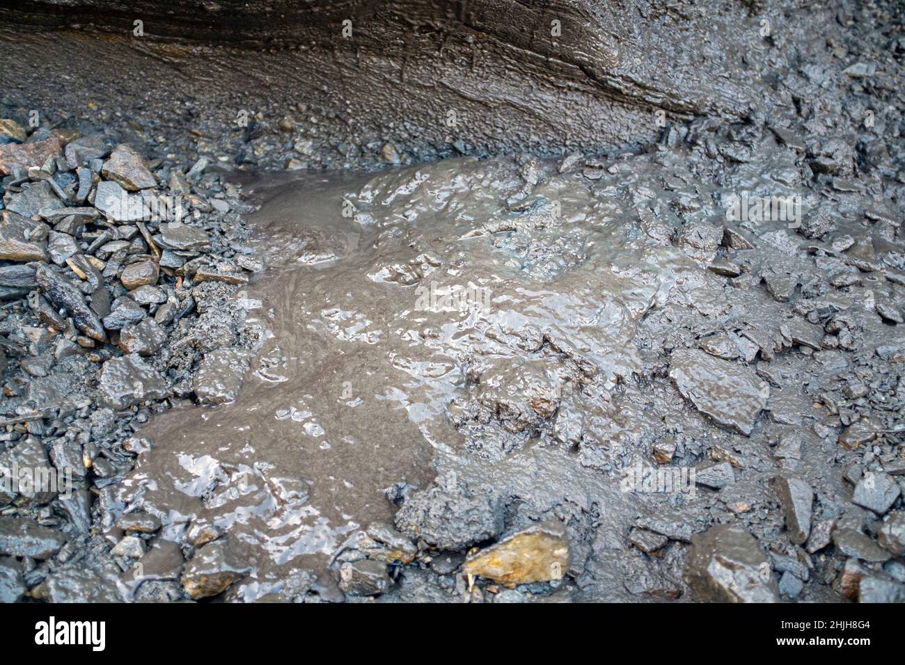 Melted permafrost flowing away as muck ontop of beadrock. Stock Photo