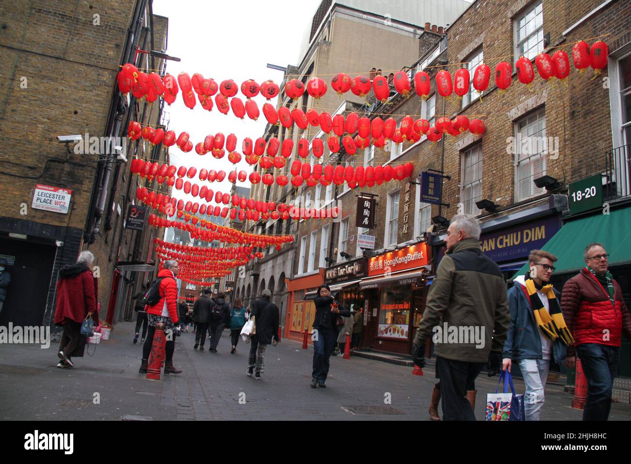 London, UK. 29th Jan, 2022. Pedestrians walk along Lisle Street in Chinatown decorated with lanterns in preparation of the Chinese New Year.Streets in Chinatown have been decorated with lanterns in preparation of the Chinese New Year. The beginning of the year of the Tiger will be celebrated on the 1st February. (Credit Image: © David Mbiyu/SOPA Images via ZUMA Press Wire) Stock Photo