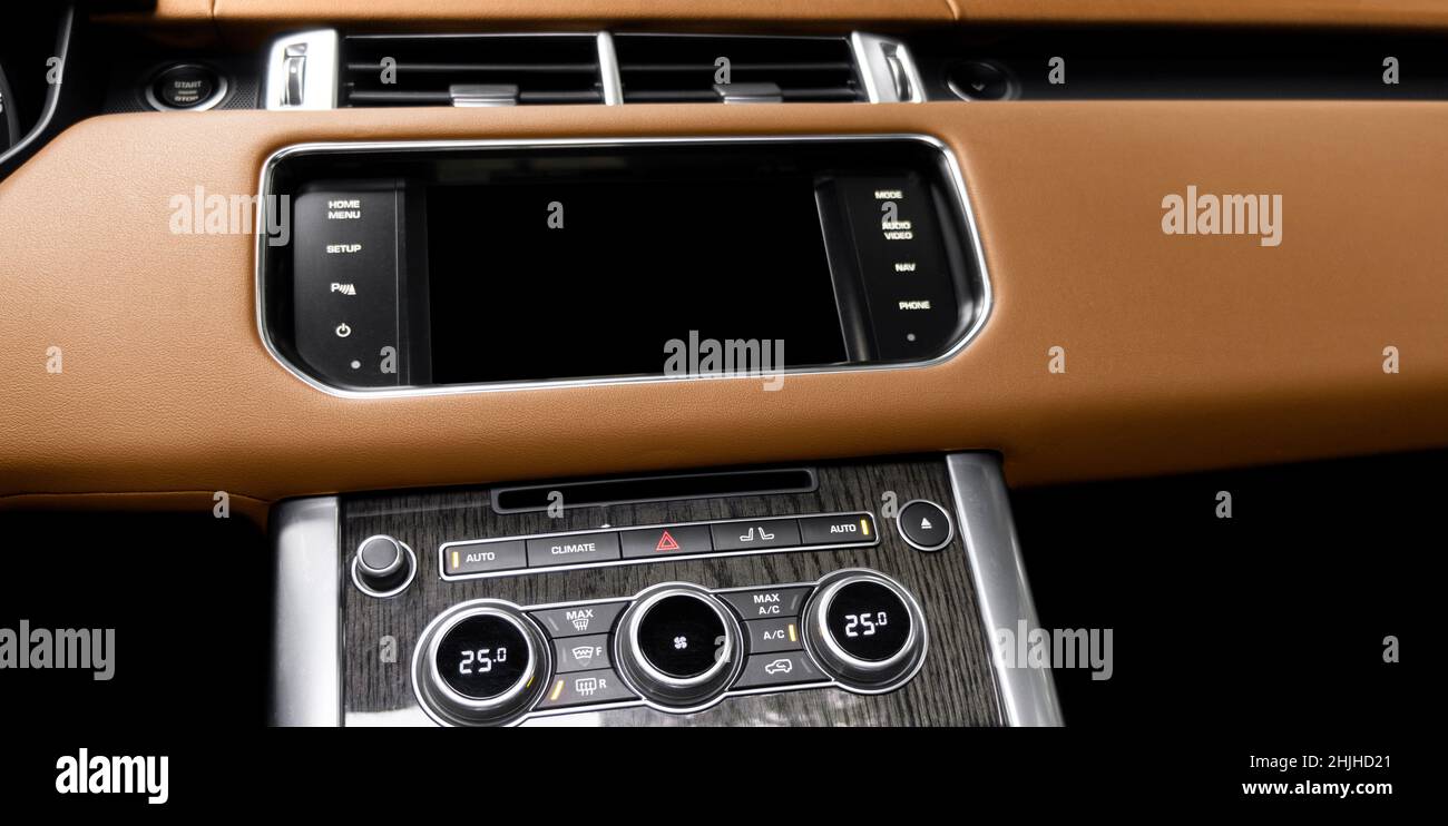 Brown luxury modern car Interior. Shift lever and dashboard. Detail of modern car interior. Automatic gear stick. Part of leather seats with stitching Stock Photo