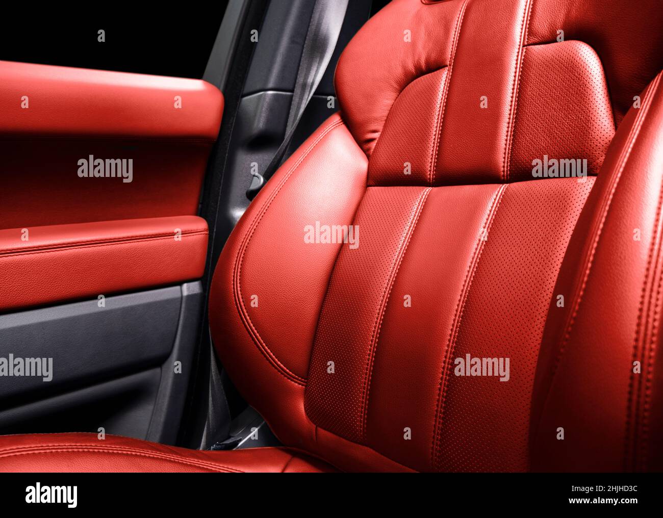 Modern luxury car red leather interior. Part of red perforated leather