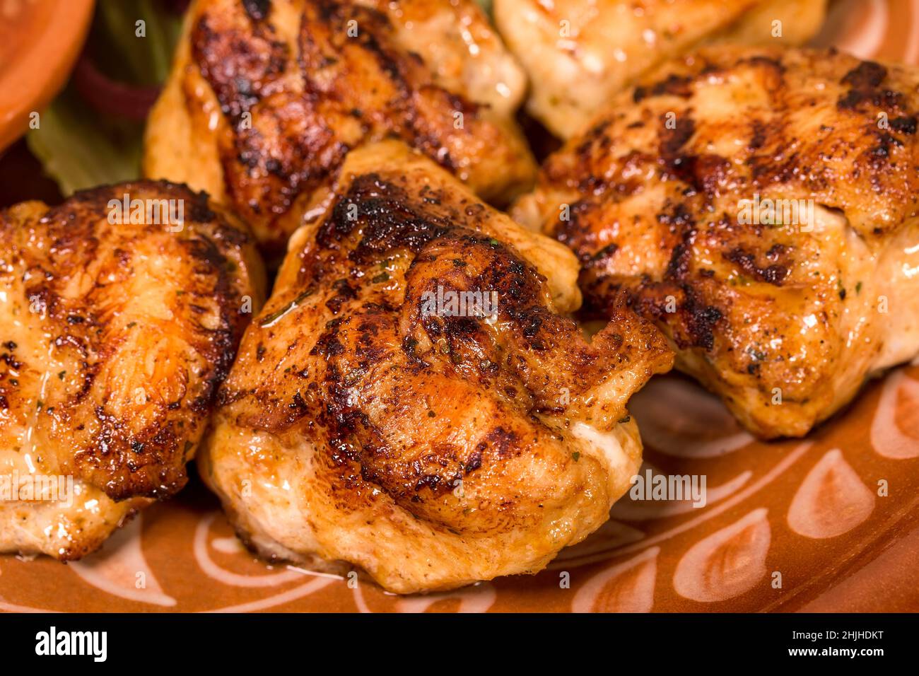 Closeup of delicious grilled chicken thighs. Can be used as a whole