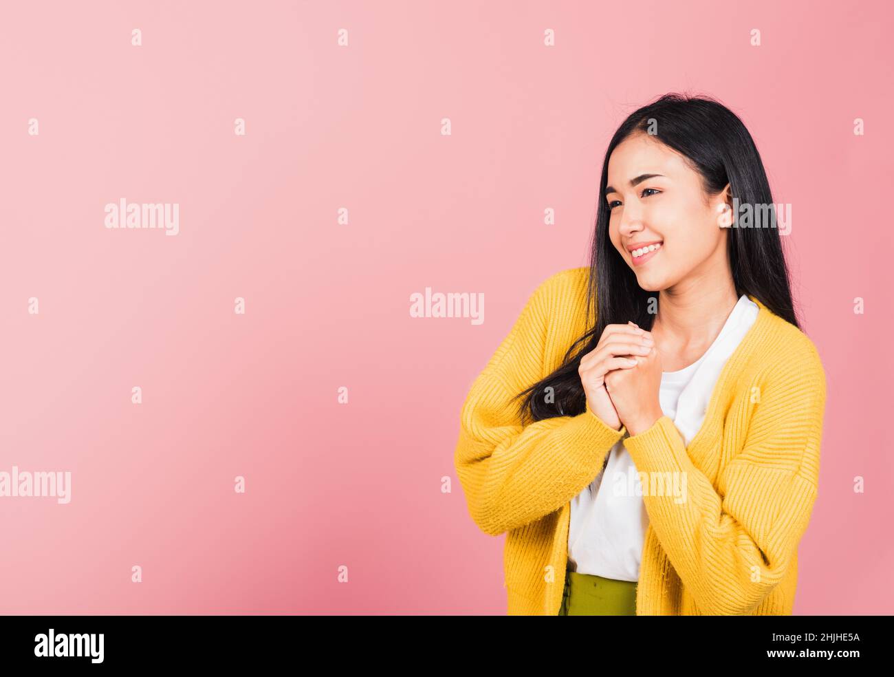 Happy Asian portrait beautiful cute young woman teen stand excited expression fist pressed together under chin pleased and delighted, thanking help st Stock Photo
