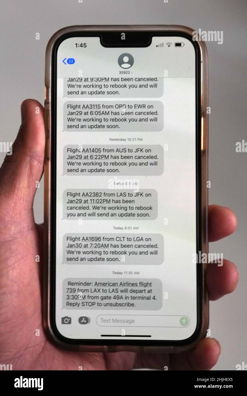 American Airlines flight cancellations to New York area airports, John F. Kennedy (JFK) and LaGuardia (LGA), amid a winter storm blizzard snow and wind advisory are displayed in text messages on an iPhone 13 Pro Max, Saturday, Jan 29, 2022, in Los Angeles. Stock Photo