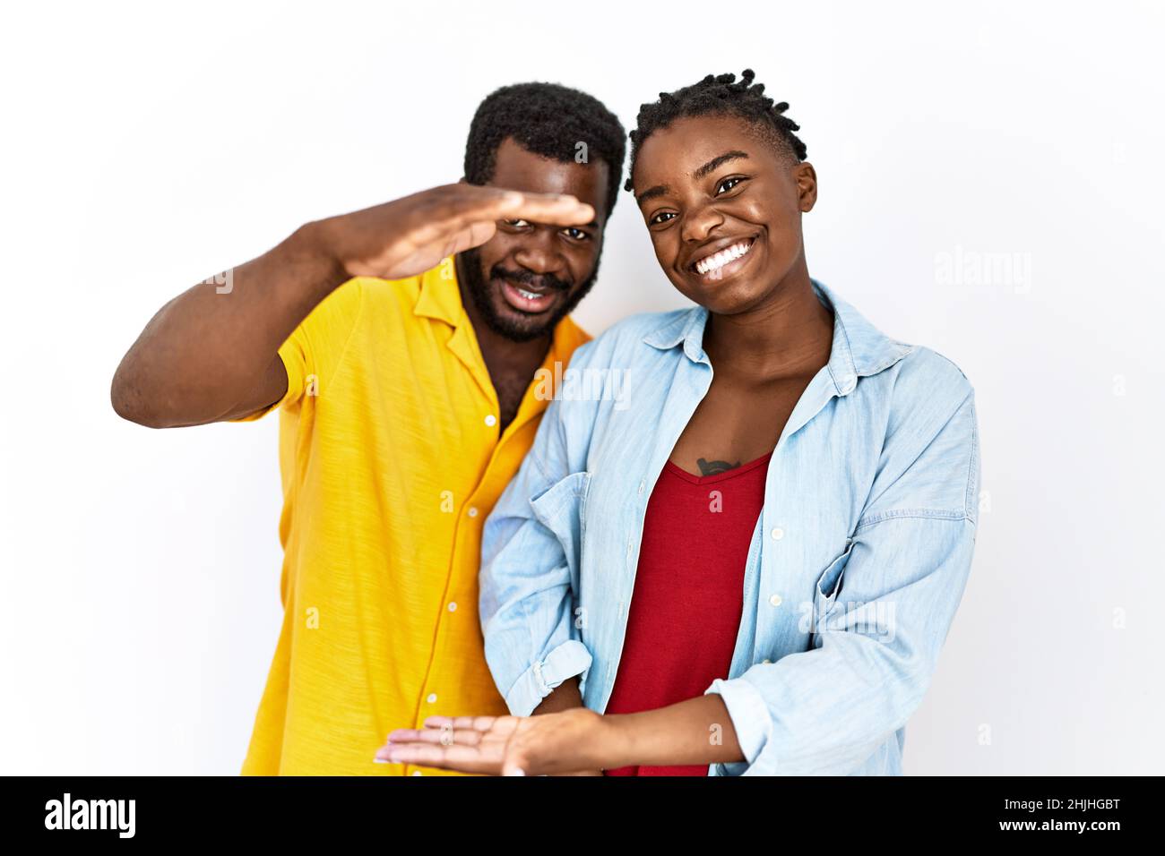 Young african american couple wearing casual clothes gesturing with ...