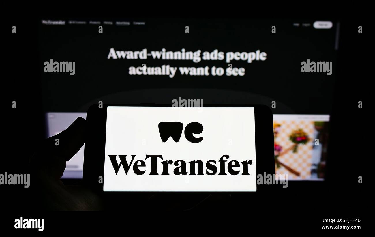 Person holding mobile phone with logo of Dutch file sharing company