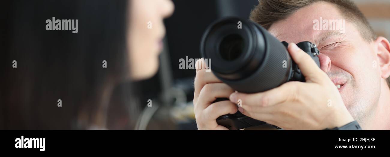 Man photographer is taking pictures of woman closeup Stock Photo