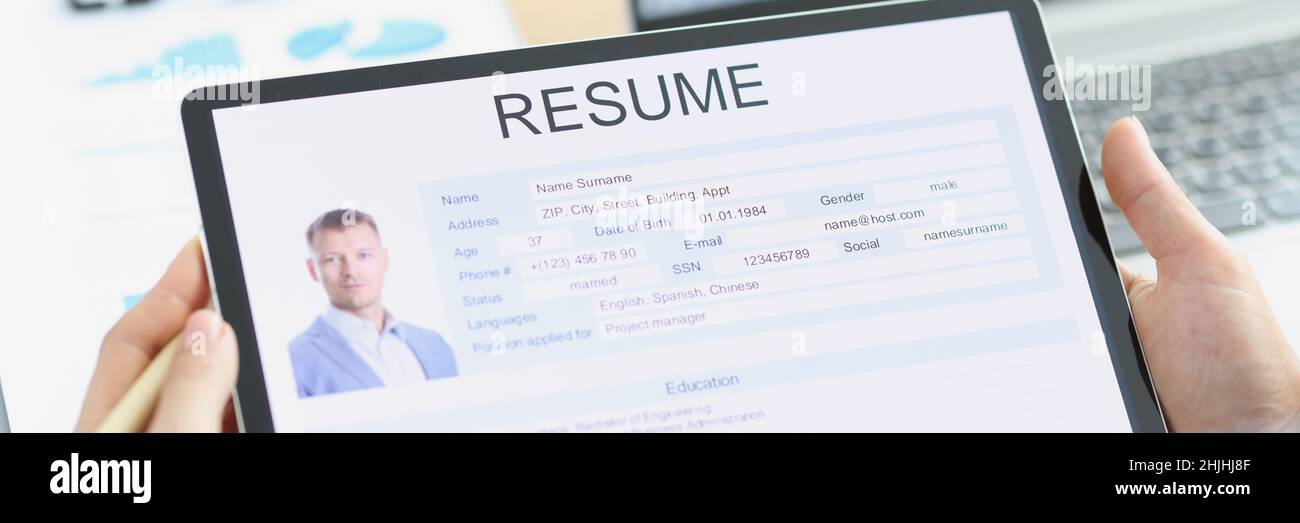 Manager examines applicant electronic questionnaire on tablet Stock Photo