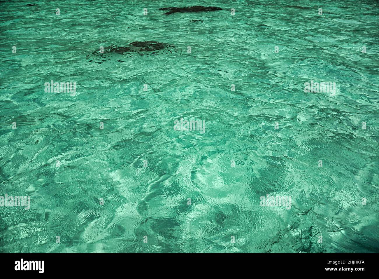 Turquoise crystal clear water on the shores of the magical island Koh Lipe Stock Photo