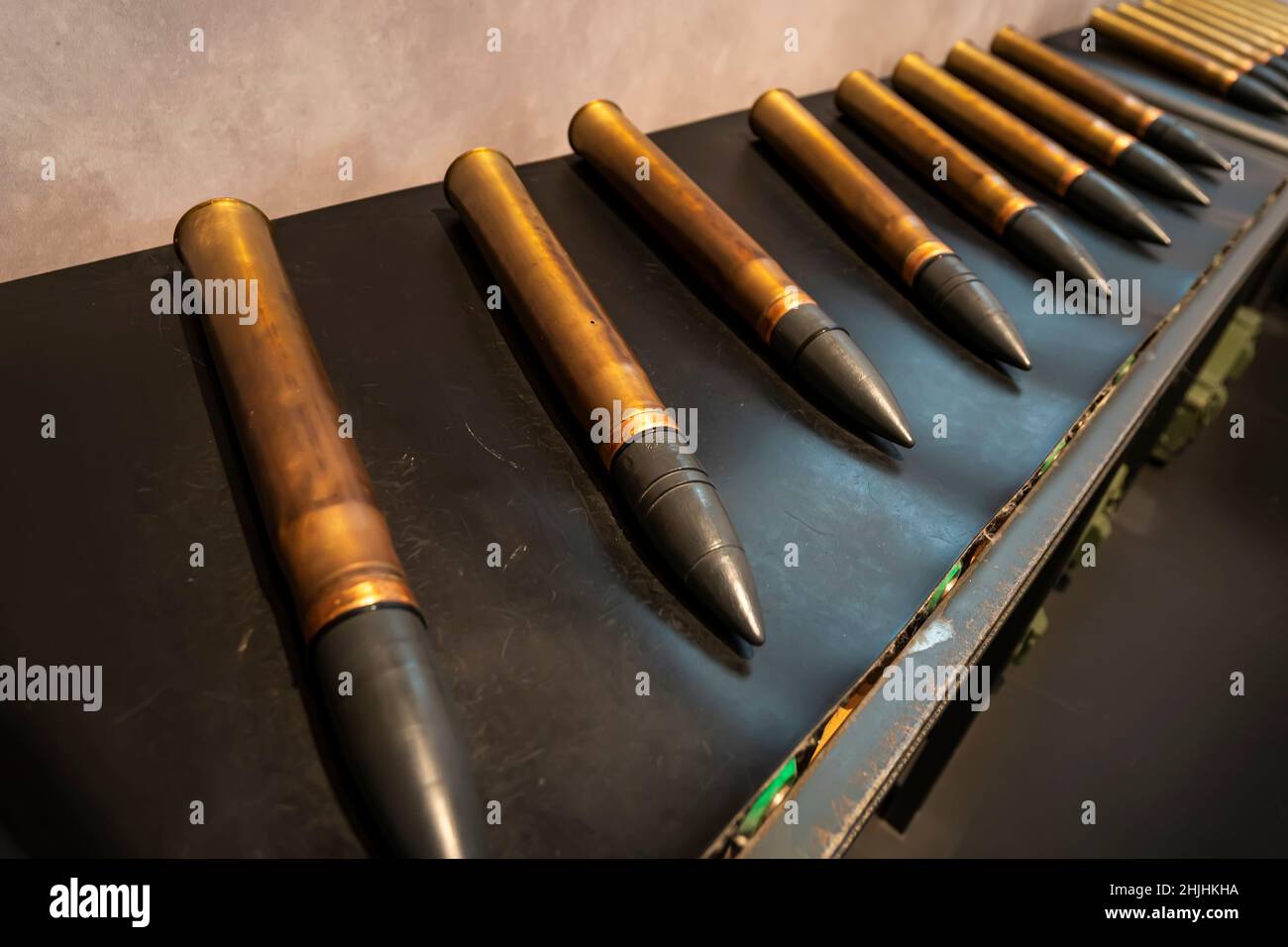Shells for the tank on the conveyor. Military industry Stock Photo