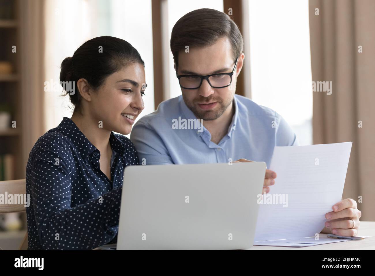 Focused young multiracial colleagues working in modern office. Stock Photo