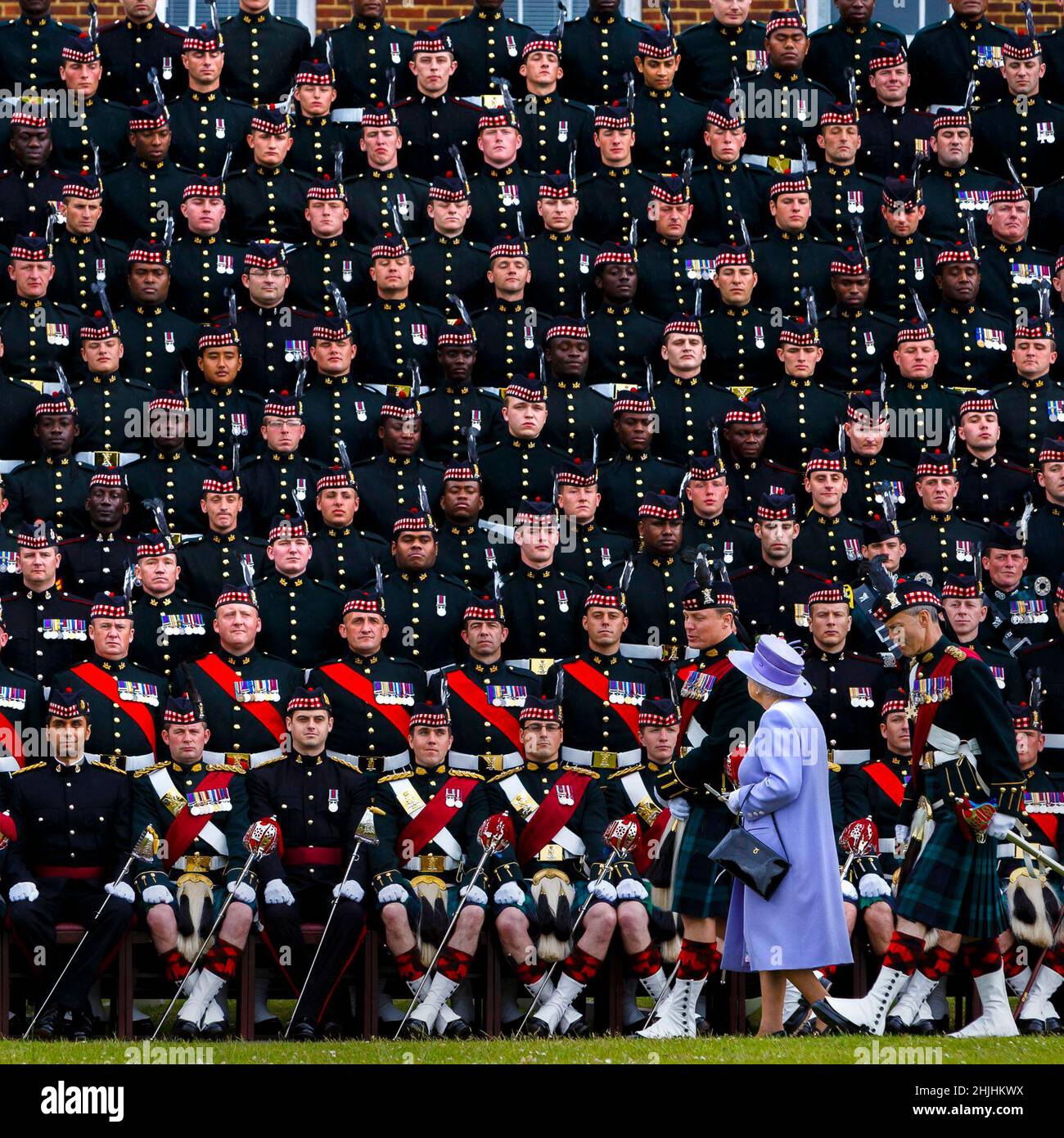 File photo dated 28/06/13 of Queen Elizabeth II joining The Argyll & Sutherland Highlanders, 5th Battalion, Royal Regiment of Scotland (5 SCOTS) for a group photograph during her visit to Howe Barracks in Canterbury, Kent. Issue date: Sunday January 30, 2022. Stock Photo