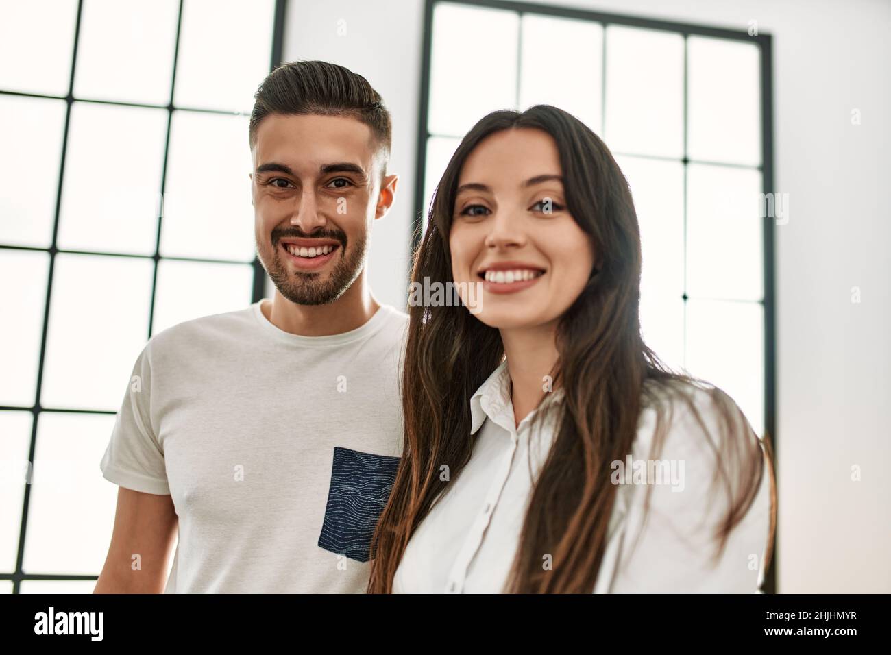 Young hispanic couple smiling happy and hugging at new home Stock Photo ...