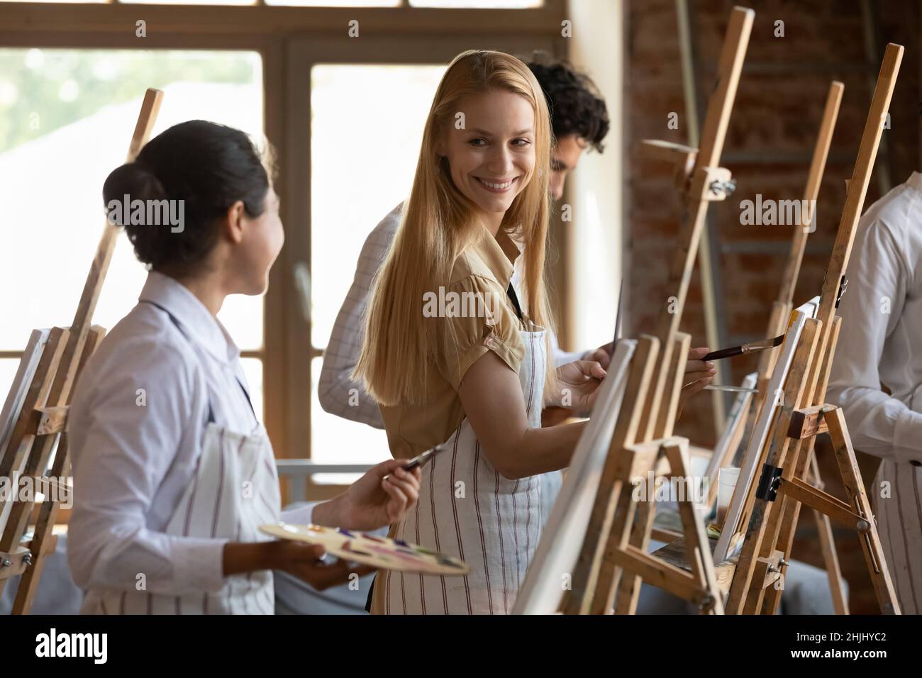 Happy hobby friends talking on art school class Stock Photo Alamy