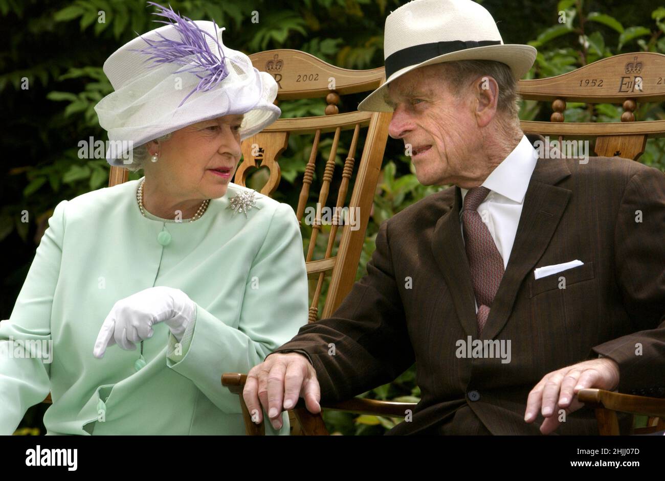File photo dated 17/7/2002 of Queen Elizabeth II and the Duke of Edinburgh talking while seated during a musical performance in the Abbey Gardens, Bury St Edmunds during her Golden Jubilee visit to Suffolk. Issue date: Sunday January 30, 2022. Stock Photo