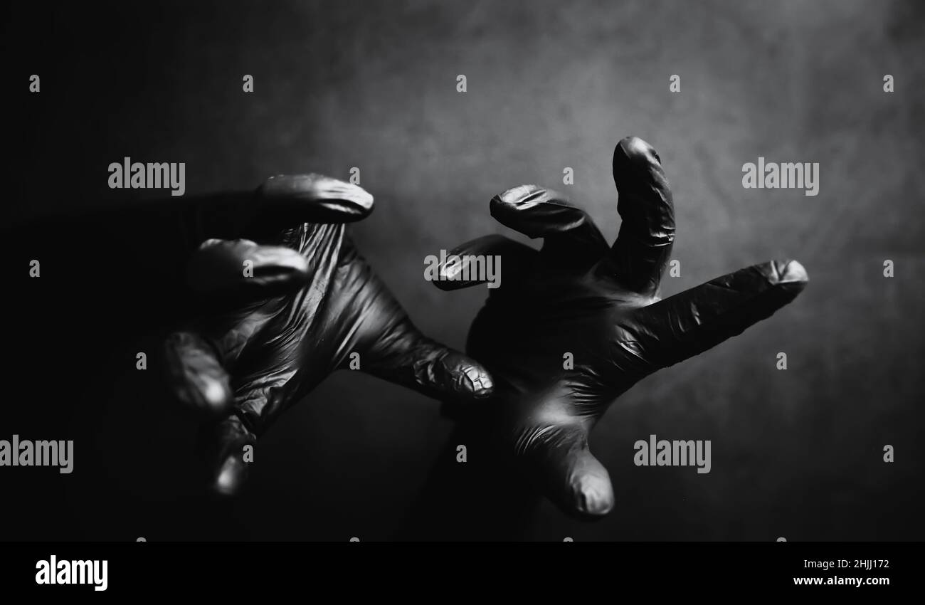 Background of hands in gloves. Black gloves. Hand gestures black gloves
