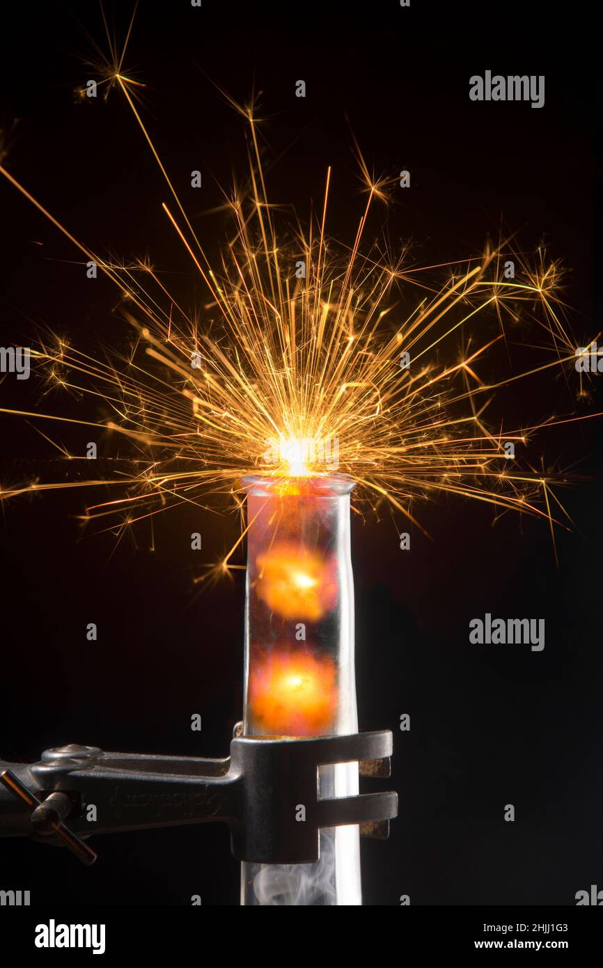 Test tube with glow, sparks and explosion Stock Photo