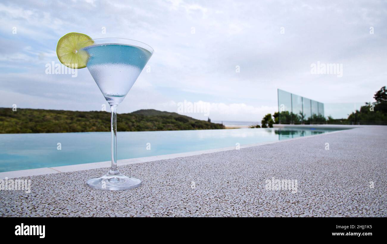 Martini glass, poolside infinitely looking out to sea… Stock Photo