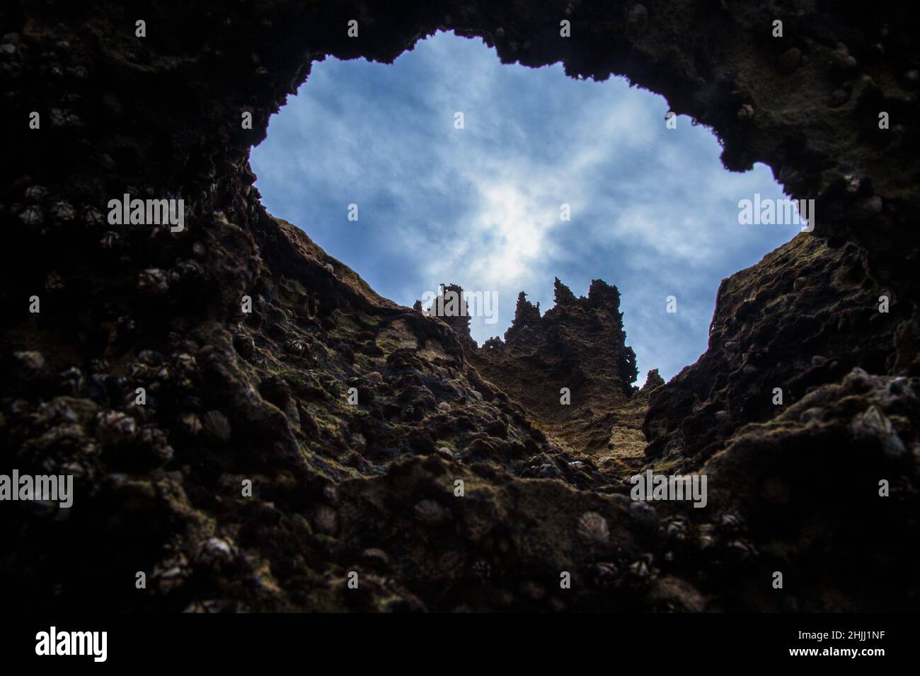 Climbing out of the cave into the light… Stock Photo