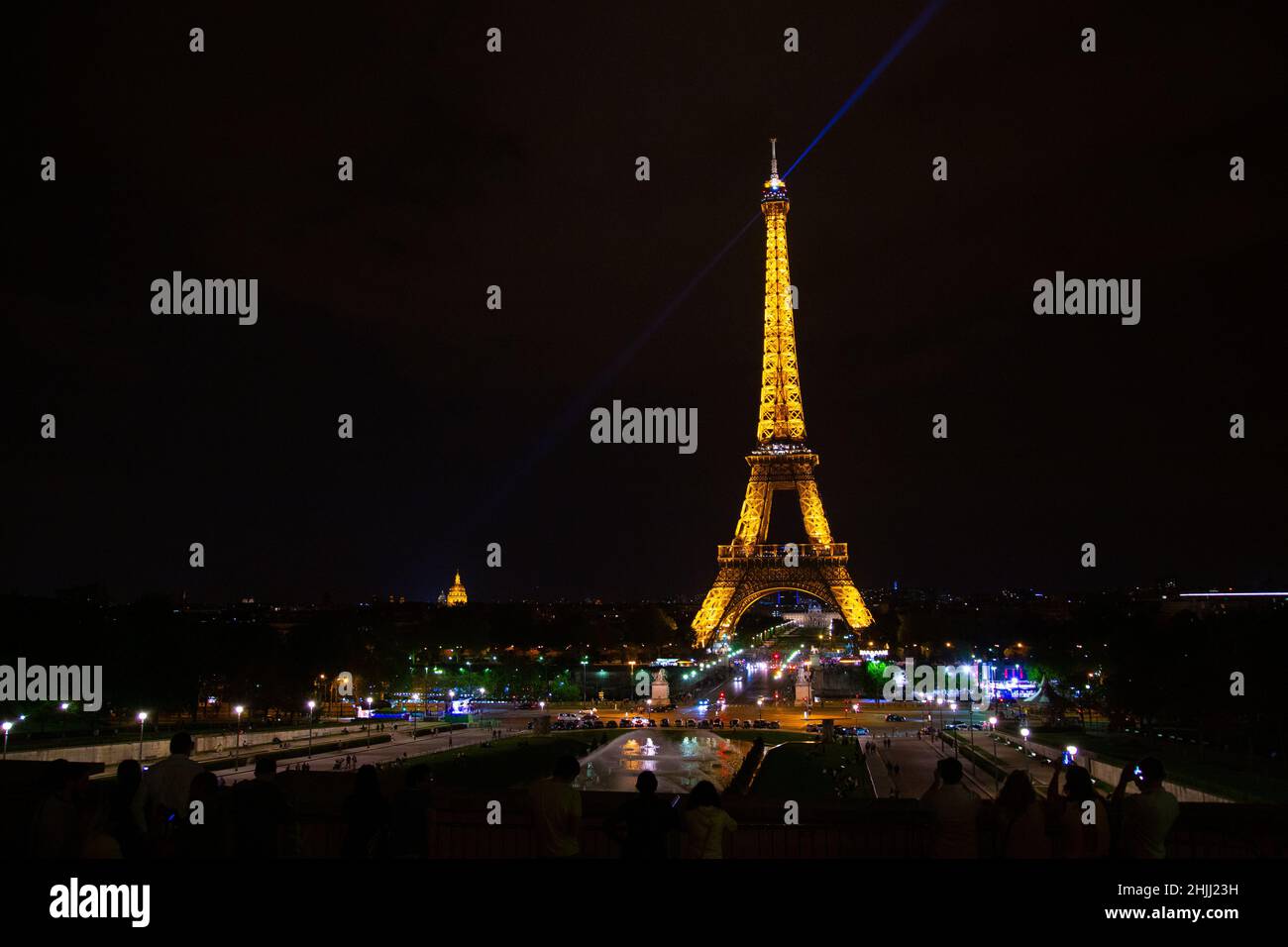 The eiffel tower lit up at night over looking the city Stock Photo Alamy